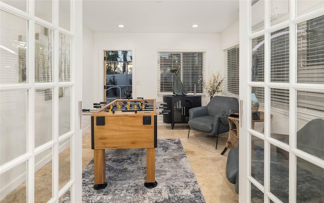 rec room featuring light tile patterned flooring