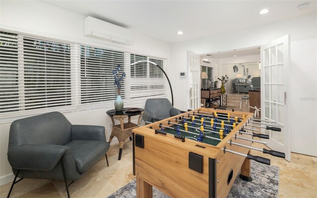 recreation room with a wall mounted air conditioner