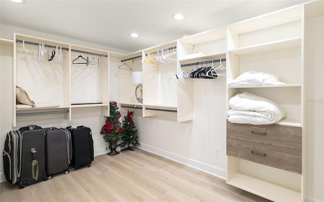 walk in closet with hardwood / wood-style floors