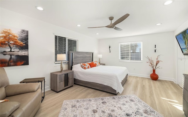 bedroom with ceiling fan and light hardwood / wood-style flooring