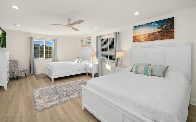 bedroom with light hardwood / wood-style flooring and ceiling fan