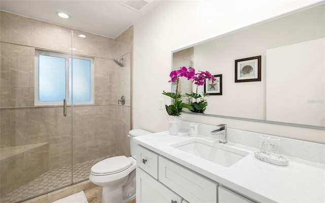 bathroom with vanity, toilet, and an enclosed shower