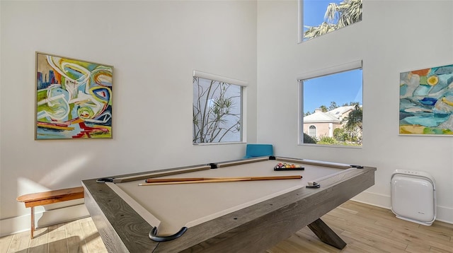 rec room with pool table, light hardwood / wood-style flooring, and a healthy amount of sunlight