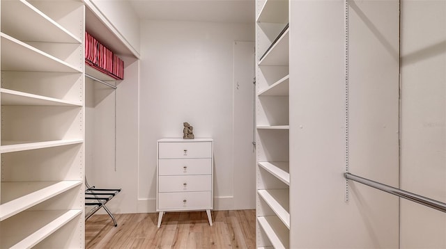 walk in closet featuring light hardwood / wood-style flooring