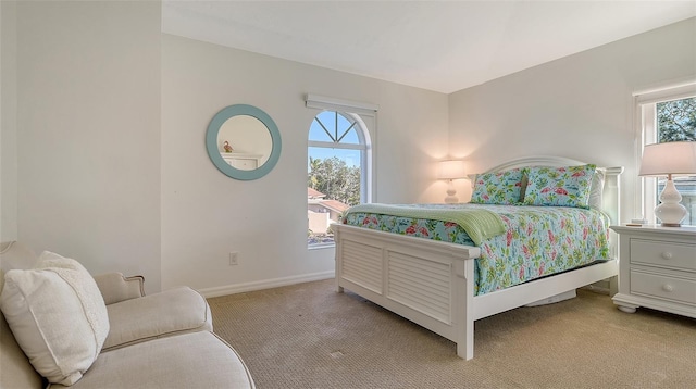 carpeted bedroom featuring multiple windows