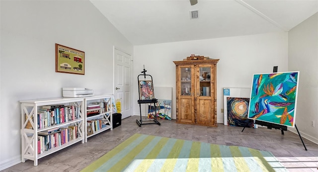 rec room featuring lofted ceiling and concrete flooring