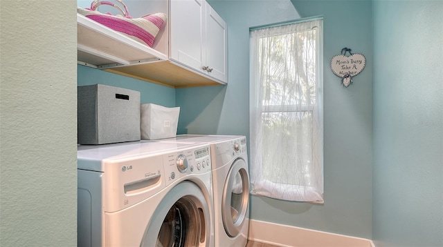 laundry room featuring cabinets and washer and dryer