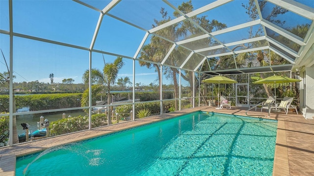 view of swimming pool featuring a patio and glass enclosure