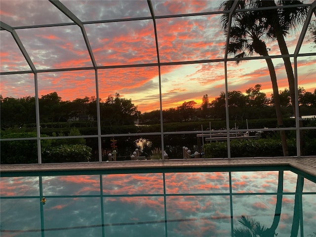 pool at dusk with glass enclosure