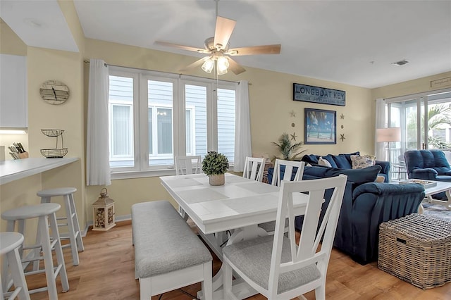 dining area featuring ceiling fan and light wood-type flooring