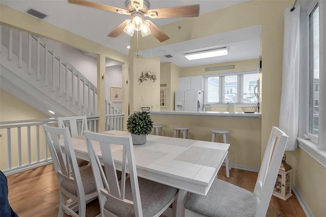 dining area featuring hardwood / wood-style flooring and ceiling fan