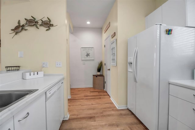 kitchen featuring white cabinetry, white appliances, and light wood-type flooring