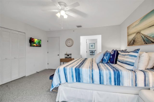 carpeted bedroom with ceiling fan and a closet