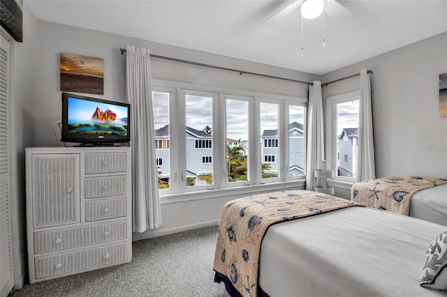 carpeted bedroom with ceiling fan