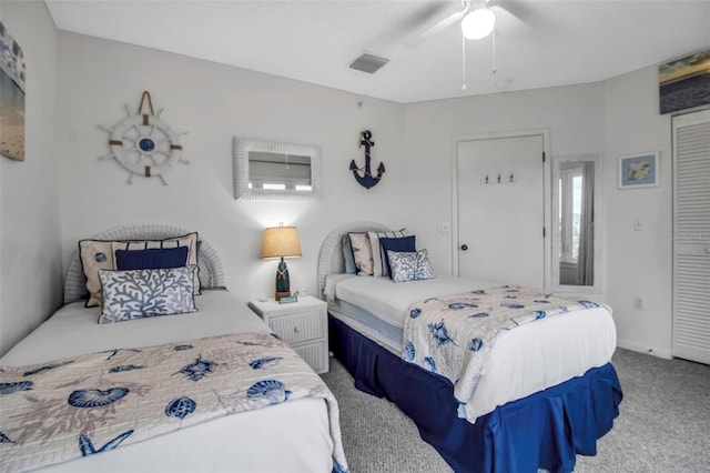 carpeted bedroom with a closet and ceiling fan