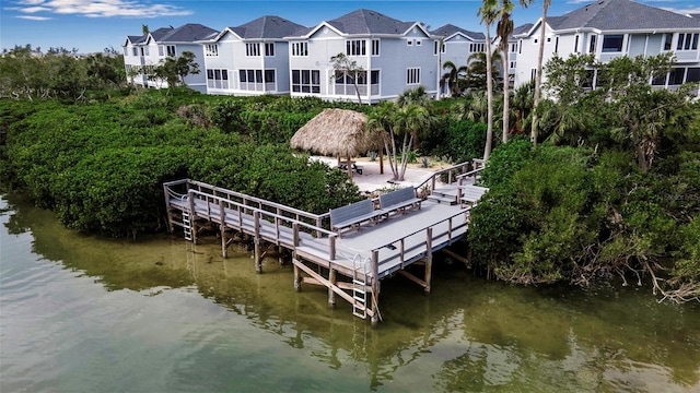 view of dock with a gazebo and a water view