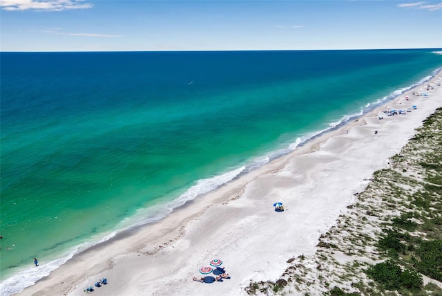 bird's eye view with a water view and a view of the beach