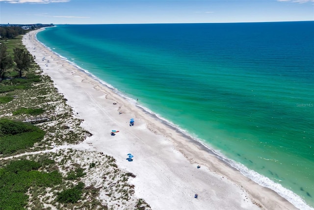 birds eye view of property featuring a view of the beach and a water view