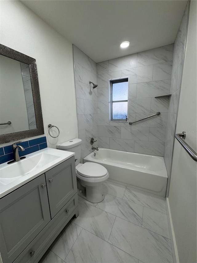 full bathroom with vanity, toilet, and tiled shower / bath