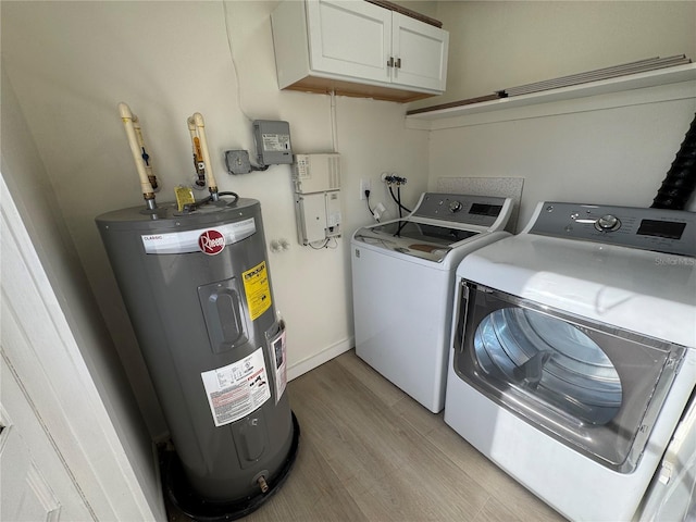 laundry room with light hardwood / wood-style floors, cabinets, washing machine and dryer, and water heater