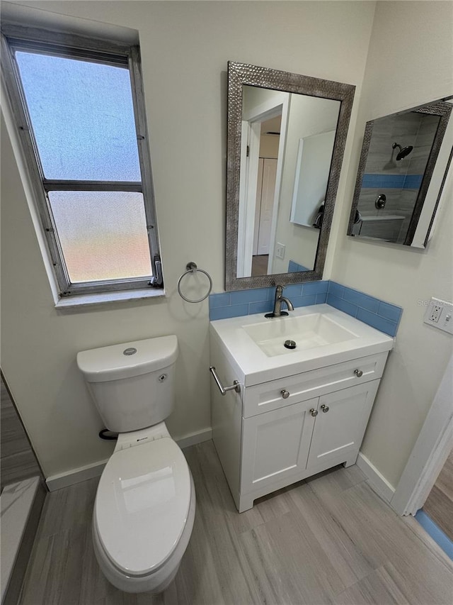 3813 42nd St W Unit 37, Bradenton, FL 34205 - bathroom with wood finished floors, vanity, toilet, and baseboards