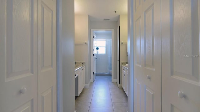 hall featuring light tile patterned floors