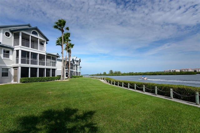 view of community with a water view and a lawn