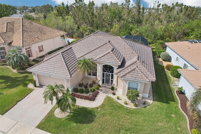 view of front facade with a front lawn, decorative driveway, an attached garage, and stucco siding