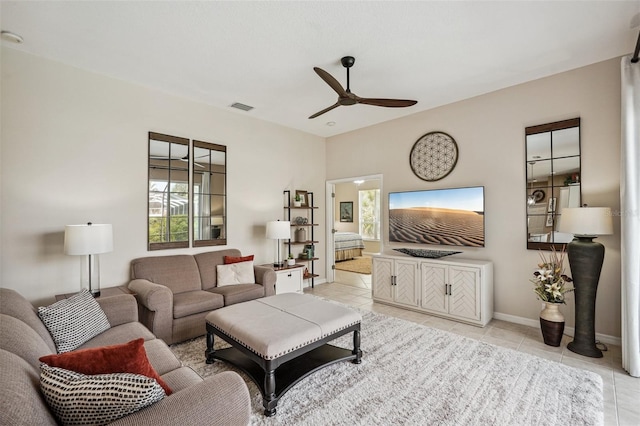 living room featuring light tile patterned floors and ceiling fan