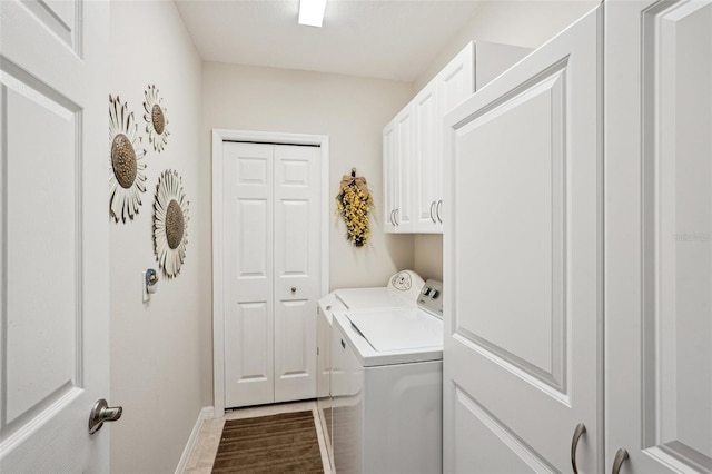 laundry area featuring cabinets and washing machine and dryer