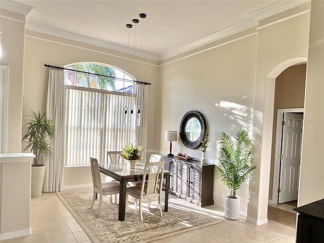 tiled dining room featuring ornamental molding