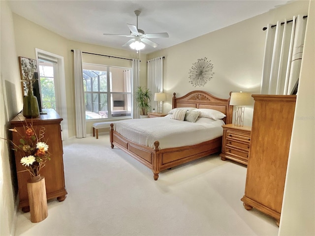 bedroom featuring a ceiling fan and light colored carpet