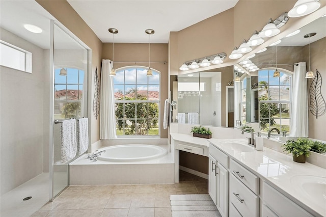 full bathroom featuring a garden tub, double vanity, a sink, a walk in shower, and tile patterned flooring