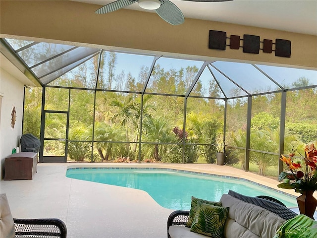 view of swimming pool with a lanai and a patio