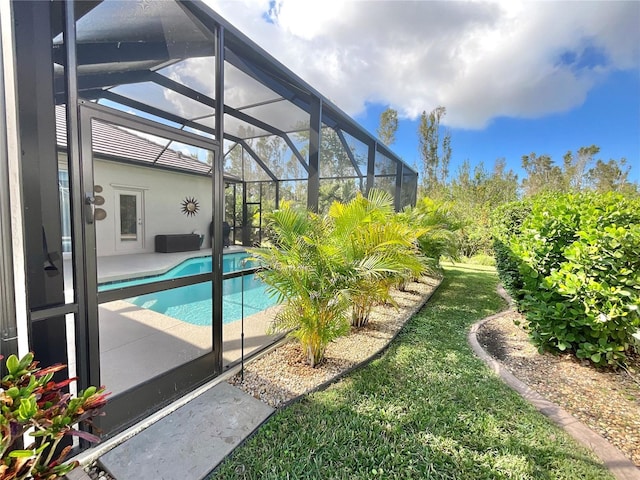 view of swimming pool with a patio area and glass enclosure