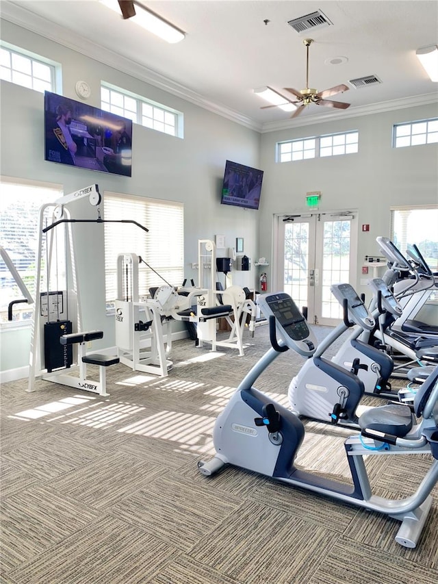 exercise room featuring french doors, ornamental molding, and carpet floors