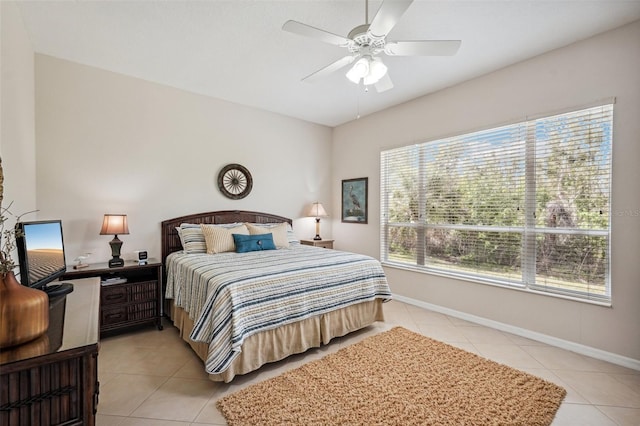 bedroom featuring ceiling fan, baseboards, and light tile patterned flooring