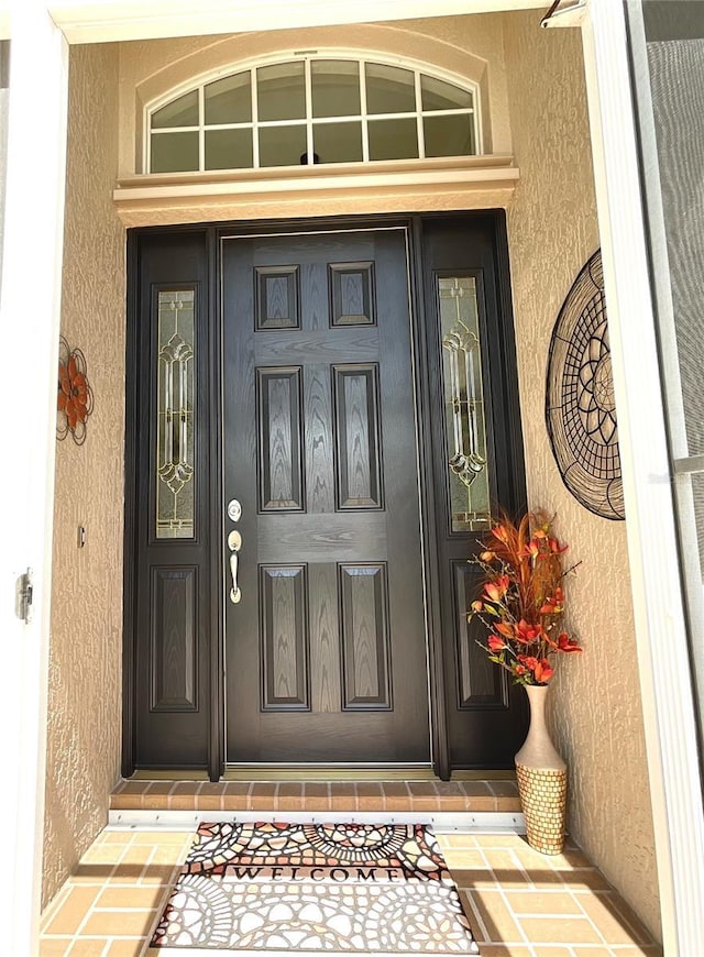 property entrance featuring stucco siding