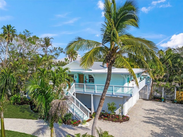 view of side of home featuring covered porch