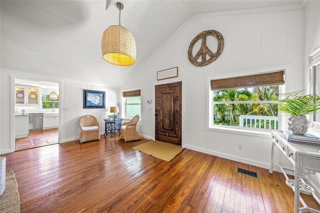 entrance foyer featuring lofted ceiling and hardwood / wood-style floors