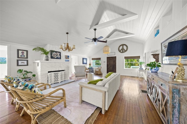 living room featuring a tile fireplace, an inviting chandelier, beam ceiling, high vaulted ceiling, and dark hardwood / wood-style flooring