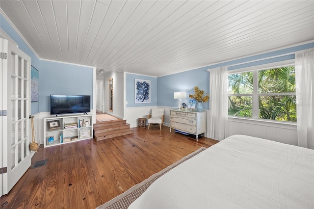 bedroom with wood-type flooring, ornamental molding, and wood ceiling