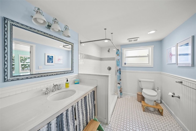 bathroom featuring toilet, vanity, and a shower with shower curtain