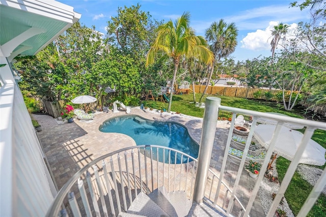 view of swimming pool featuring a yard and a patio area