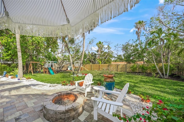 view of patio / terrace with a playground and an outdoor fire pit