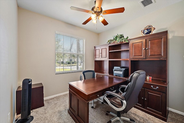 carpeted office space with ceiling fan