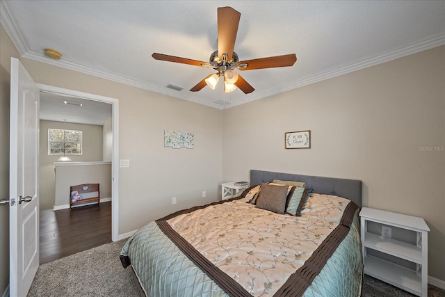 bedroom with dark colored carpet, crown molding, and ceiling fan