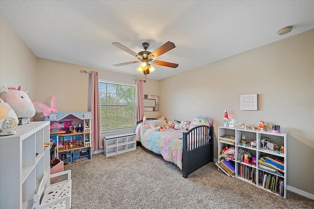 bedroom featuring ceiling fan, carpet floors, and a textured ceiling