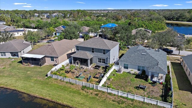 birds eye view of property with a water view