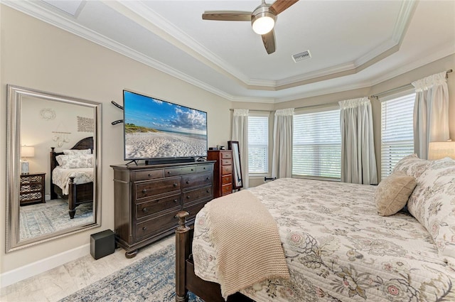 bedroom with a raised ceiling, crown molding, ceiling fan, and light wood-type flooring